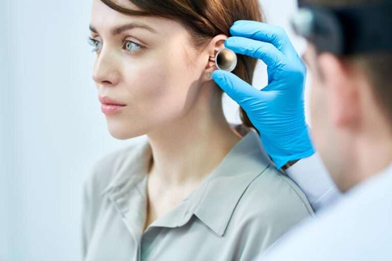 audiologist-examining-ears-RHX49G8